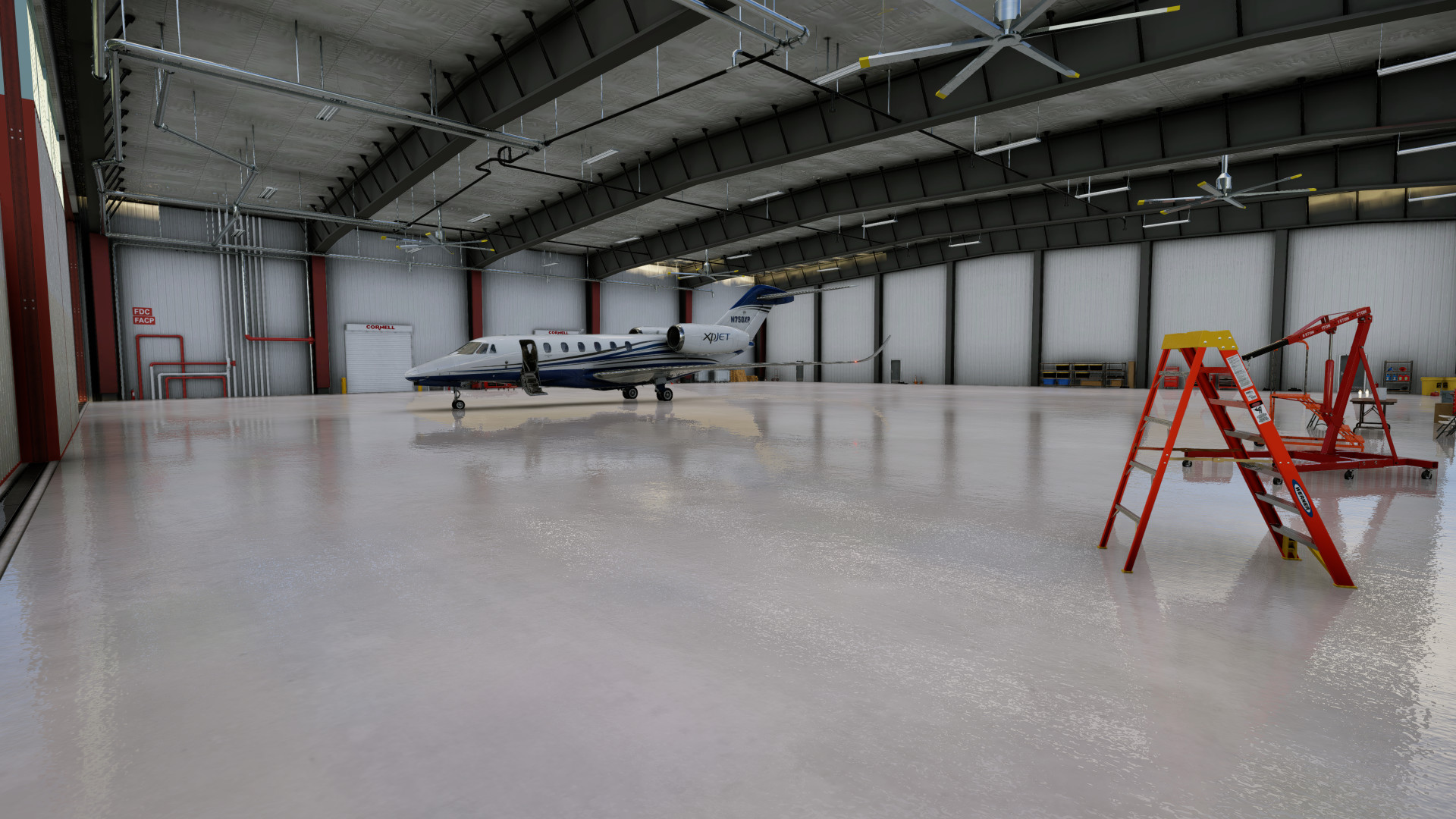 View of Citation parked inside Hangar 30 with equipment along the hangar walls at KTEX Telluride Regional Airport in X-Plane 12