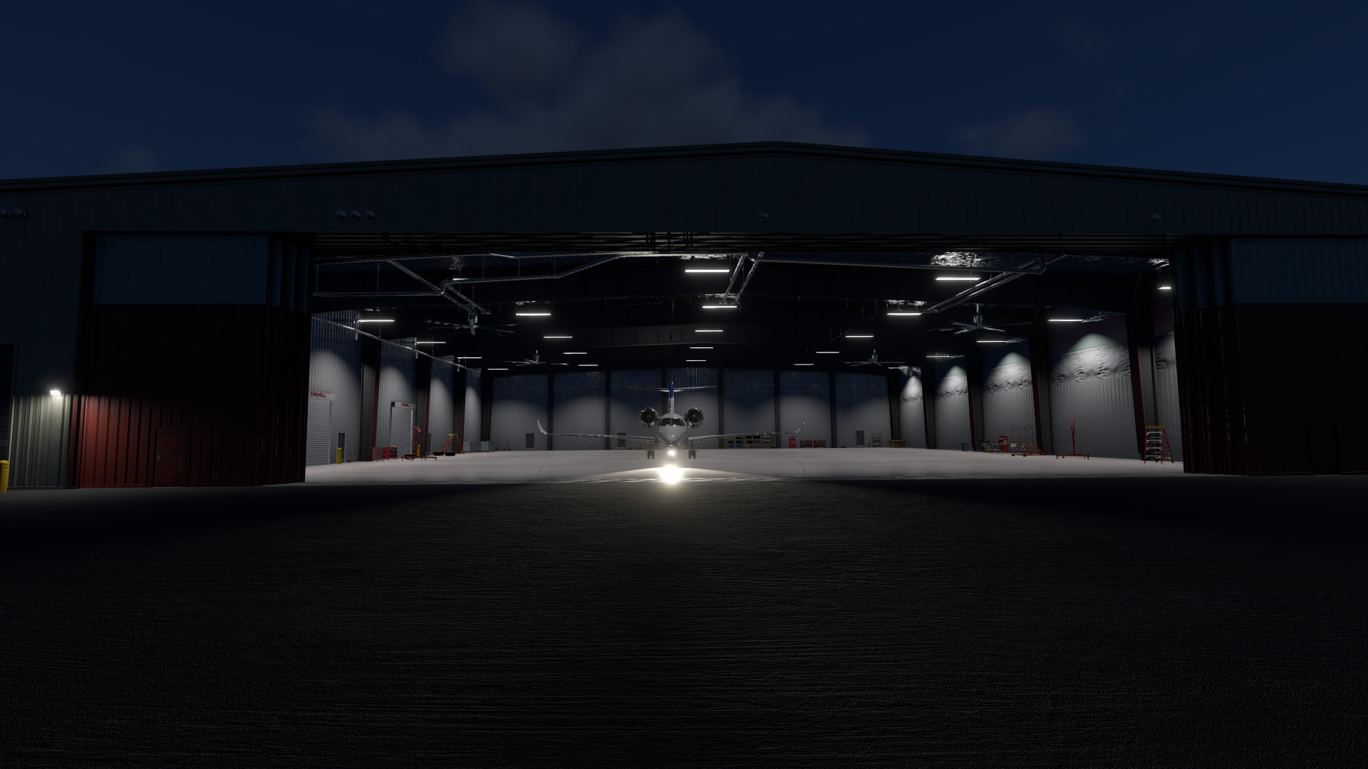 Night view looking into Hangar 30 with Citation parked inside with taxi lights on at Telluride Regional Airport in X-Plane 12